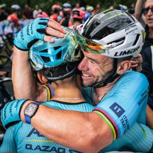 Mark Cavendish hugs a teammate after his record-breaking win on stage 5 of the 2024 Tour de France.